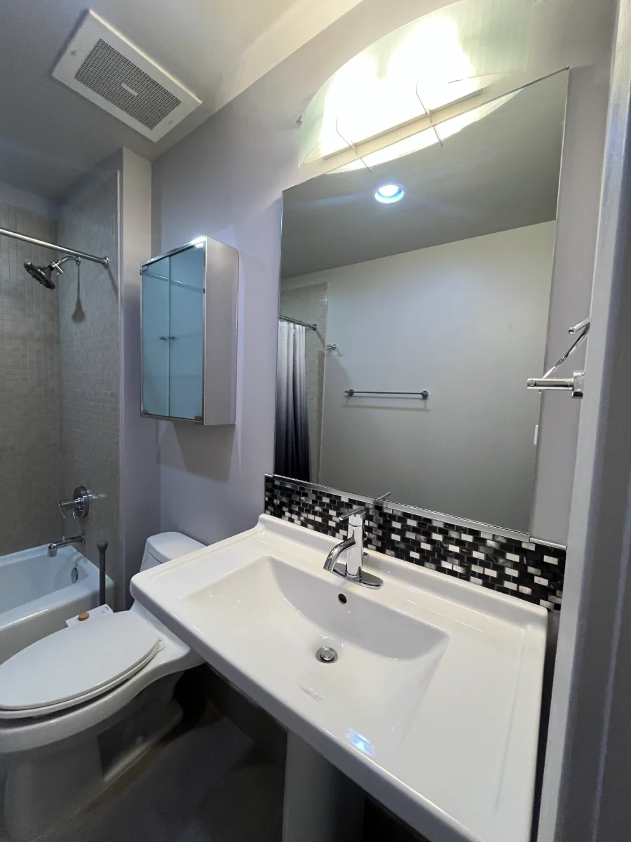 Freshly cleaned bathroom with bright sink and mirror